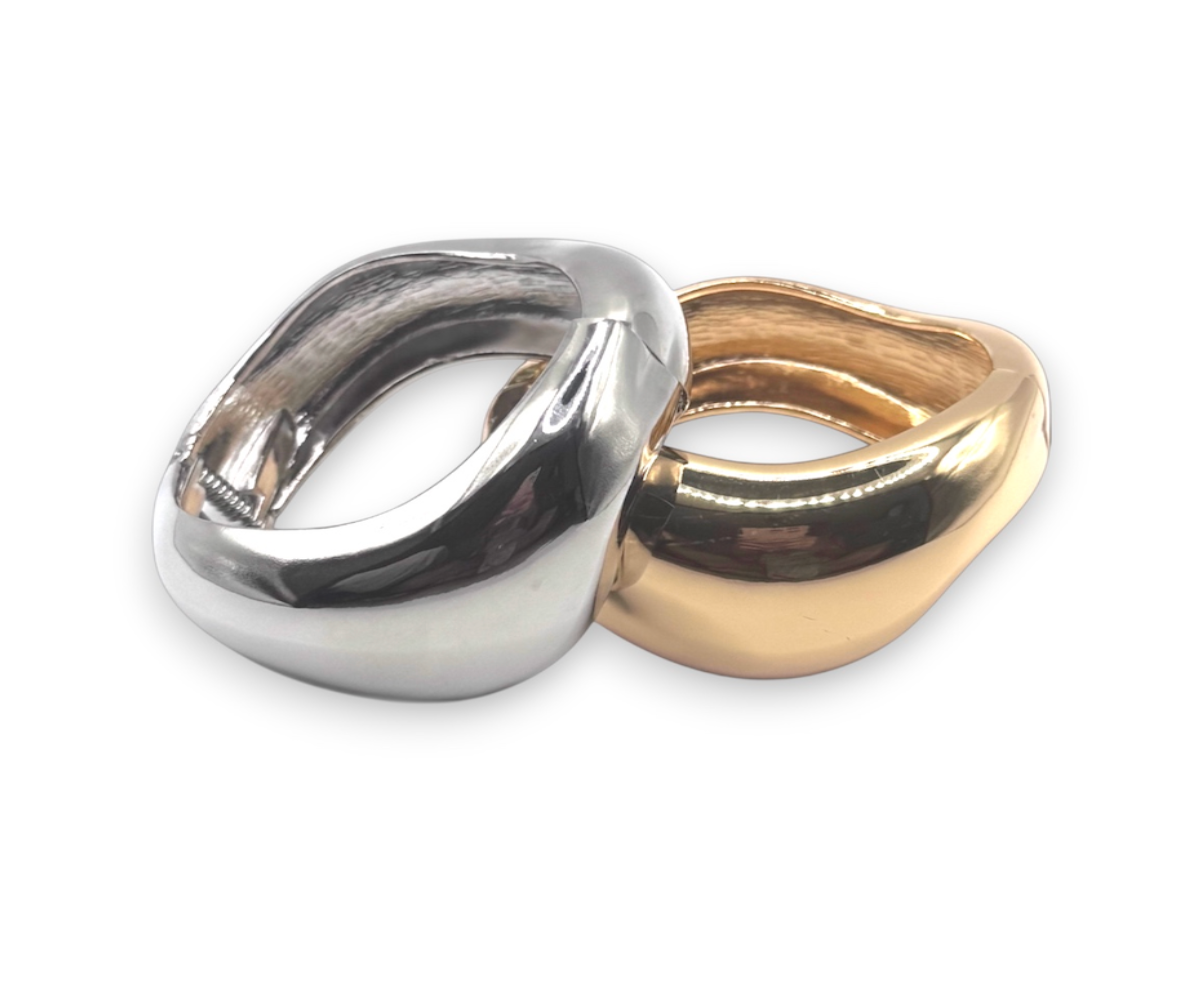 Two metallic rings, one silver and one gold, on a white background